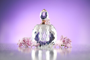 Beautiful lilac flowers and perfume on mirror surface against violet gradient background