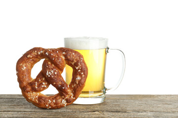 Tasty pretzel and glass of beer on wooden table against white background. Space for text