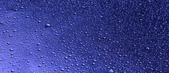 Close-up of water drops. Raindrops, on the surface of a car. Gradient from dark to light.  Set it up as a cool background.  Dimensional, wallpaper.