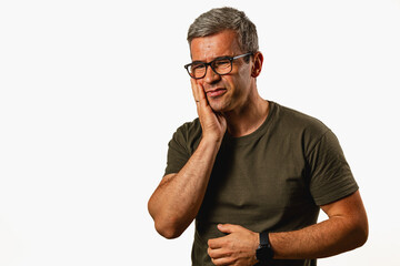 Man expressing concern against a simple backdrop indoors