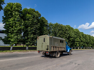 Obraz premium A military truck travels along the asphalt road