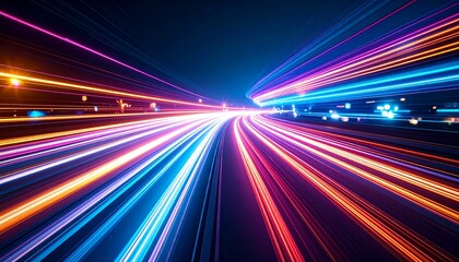 Colorful light streaks stream powerfully forward at high speed across a dark blue background creating a dynamic and vibrant abstract motion blur effect.