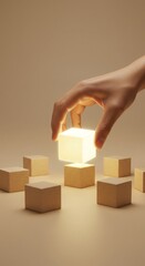 Hand placing illuminated cube among wooden blocks on neutral background