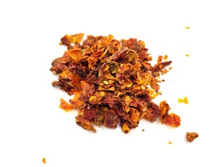 Dried pieces of chopped tomatoes on a white background.
