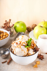 Homemade apple pie ice cream. Bowl of traditional autumn apple pie or strudel gellato, with caramelized apples, sponge cake biscuit crumble, caramel sauce, cinnamon and spices