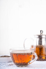 Chia seeds tea, trendy healthy chia infused drink, alternative natural energy source, diet weight-loss drink, in teapot and tea cup, copy space