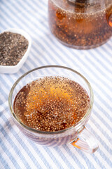 Chia seeds tea, trendy healthy chia infused drink, alternative natural energy source, diet weight-loss drink, in teapot and tea cup, copy space