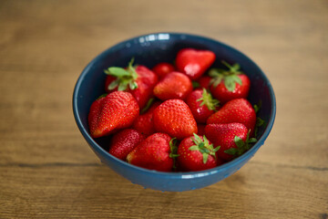 A beautifully vibrant bowl filled with fresh strawberries, showcasing their rich color, sweetness, and natural allure