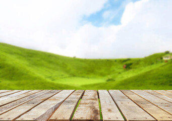 Wooden table top on blur mountain and grass field.Fresh and Relax concept.For montage product display or design key visual layout.View of copy space.