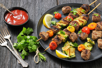 beef kebabs with zucchini and tomatoes on skewers