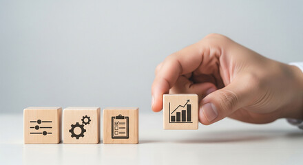 Businessman places a wooden block with a growth graph icon next to others showing controls, a gear, and a checklist. Symbolizes business process optimization and strategic progress