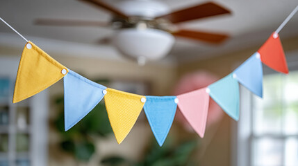 Colorful kids birthday banner in motion from ceiling fan for party decor