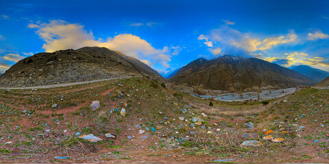 Full 360 panorama of dramatic mountain range over a peaceful valley in Kyrgyzstan, equirectangular...
