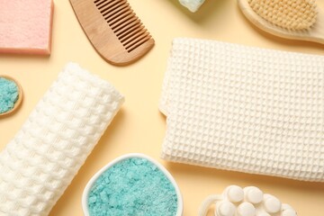 Clean waffle towels, cosmetic products and supplies on beige background, flat lay