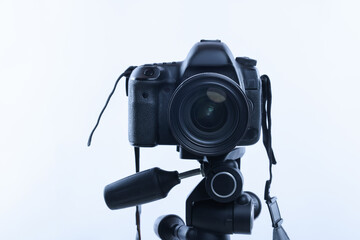 Modern professional video camera on white background
