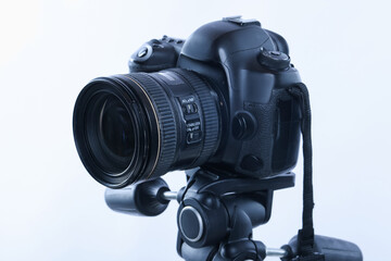 Modern professional video camera on white background, closeup