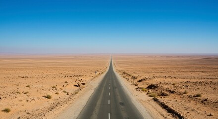 Empty highway stretches into a vast desert landscape