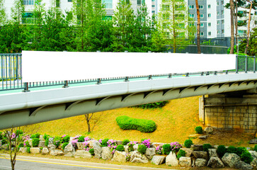 Long white vinyl banner fixed on metal bridge handrail outdoor. Public commercial advertising...