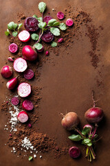 Brown surface with sliced radishes and earthy vegetables