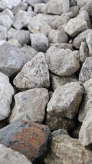 Rock Aggregate Texture: A raw, close-up texture of gray rock aggregate, perfect for conveying industrial strength, natural beauty, or geological themes.