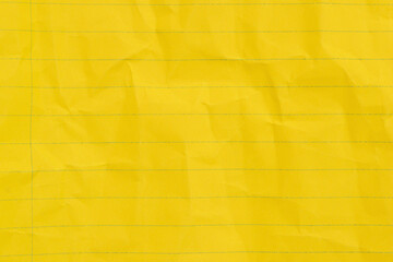 Crumbled yellow lined loose leaf notebook paper background
