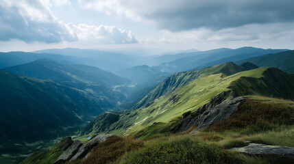 Naklejka premium Expansive view of lush green mountain ridges under cloudy sky