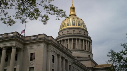 Visitors admire the stunning golden dome of the West Virginia State Capitol, surrounded by...