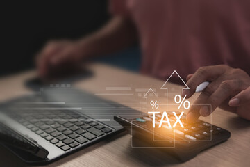 Calculating income for tax planning. Reviewing tax filing to ensure accuracy and compliance to reduce risks effectively. Man working with calculator and laptop in dimly lit office, Retirement planning