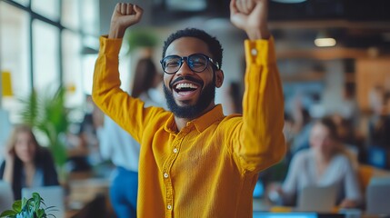 Joyful man celebrating success in a vibrant workspace.
