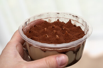 This is a delicious Tiramisu dessert served in a beautiful transparent cup that everyone loves