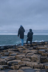 Person exploring Giant's Causeway, Ana of Hexagonal Basalt Stones, Created by Ancient Volcanic...