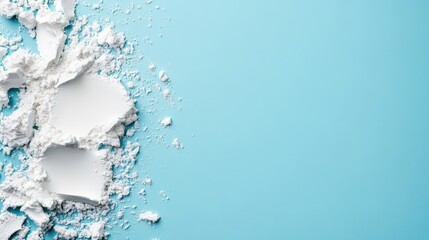 Fototapeta premium A dynamic composition of white flour scattered across a vibrant teal surface illustrates the artistry of baking and the beauty of simple ingredients in culinary creations.