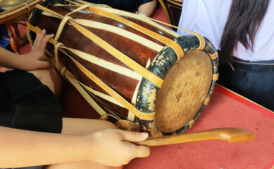 A person is holding a drum