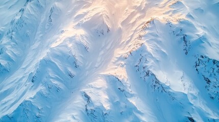 Majestic aerial view of snowy mountain peaks under clear blue skies in winter
