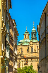A view down an ornate side street towards some of the many spires in central Prague in springtime