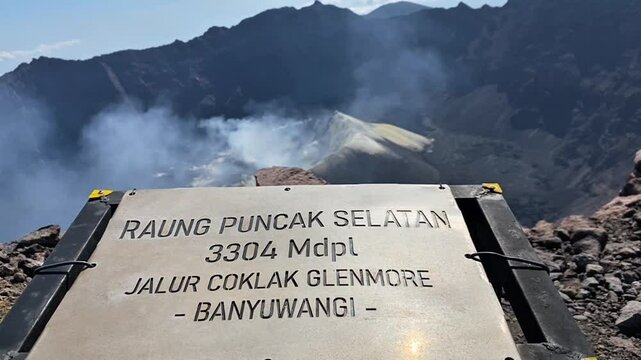 mount raung south peak plaque, coklak glenmore lane, banyuwangi, indonesia. with caldera view in the background