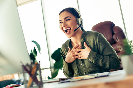Excited Businesswoman Expressing Joy and Enthusiasm While Working in a Modern Office Environment Wearing a Stylish Outfit