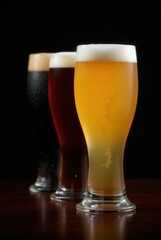 Assorted Craft Beer Selection: Three glasses showcasing a diverse range of craft beer styles, from a light ale to a dark stout, lined up against a sleek backdrop.