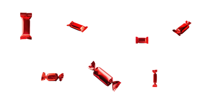 Various red-wrapped candies arranged in a scattered formation on a transparent background highlighting their glossy texture and colorful appearance.