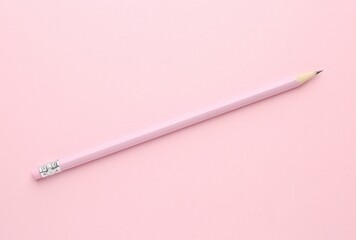 One graphite pencil on pink background, top view
