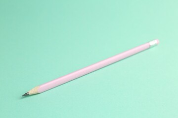 One graphite pencil with eraser on turquoise background, closeup