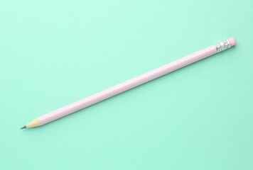 One graphite pencil with eraser on turquoise background, top view