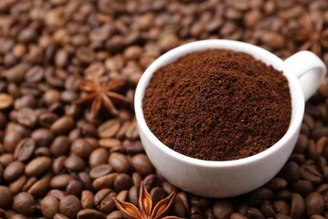 Cup with instant coffee powder and star anise on beans, closeup. Space for text