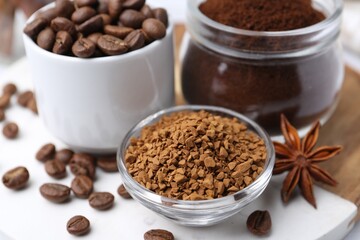 Different types of instant coffee, beans and spices on table, closeup
