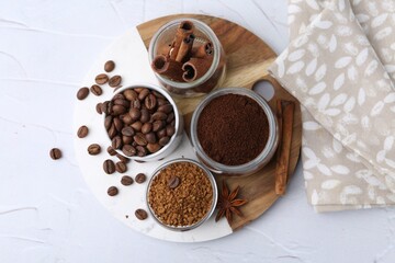 Different types of instant coffee, beans and spices on light textured table, top view