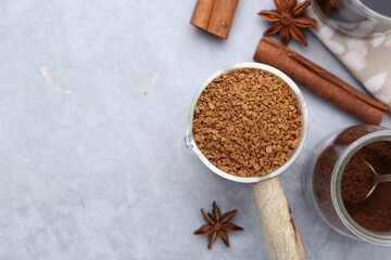 Different types of instant coffee and spices on grey textured table, flat lay. Space for text