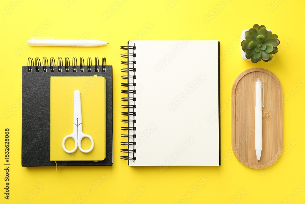 Poster flat lay composition with open blank notebook on yellow background