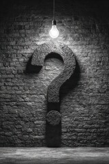 Large Dark Question Mark on Wall with a Light Above it