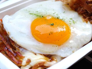 Sunny side up egg on Okonomiyaki. Japanese pancake.