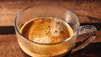 Crema of hot espresso shot. 